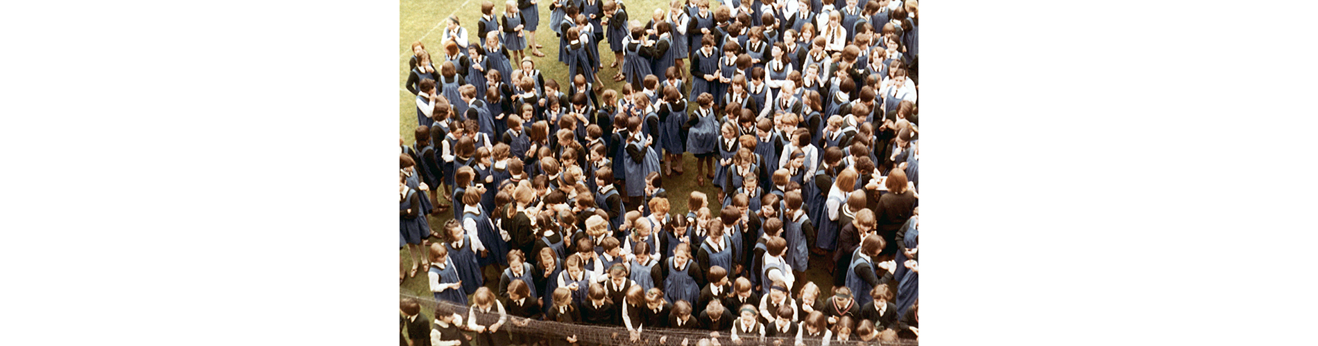 Fondly remembered by some girls, the blue pinafore was required uniform until 1996, when the Girls' school merged with the Boys school to become Berkhamsted Collegiate.